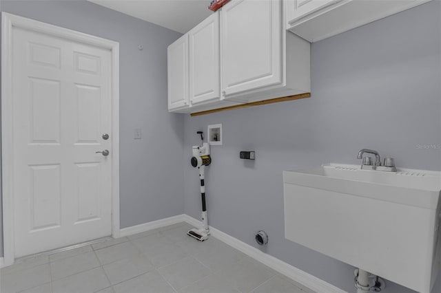 15038 Willow Ln, Tavares, FL 32778 - laundry area featuring hookup for a washing machine, cabinet space, and light tile patterned floors