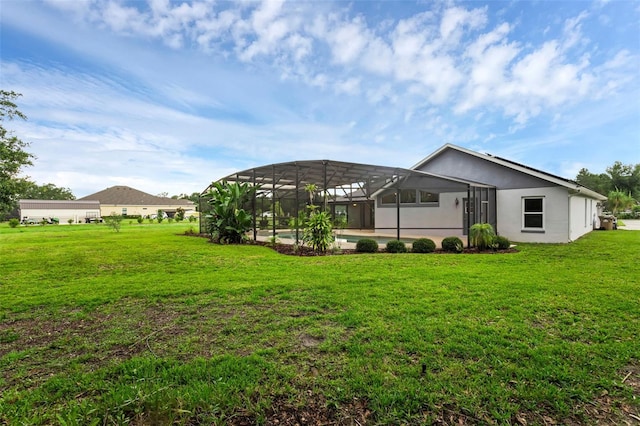 15038 Willow Ln, Tavares, FL 32778 - back of property with stucco siding, a yard, and glass enclosure