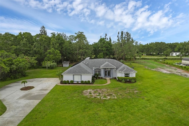 15038 Willow Ln, Tavares, FL 32778 - ranch-style house featuring french doors, a front yard, and concrete driveway