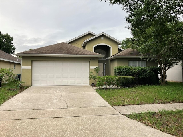 11236 Rouse Run Cir, Orlando, FL 32817 - view of front facade with stucco siding, a garage, driveway, and roof with shingles