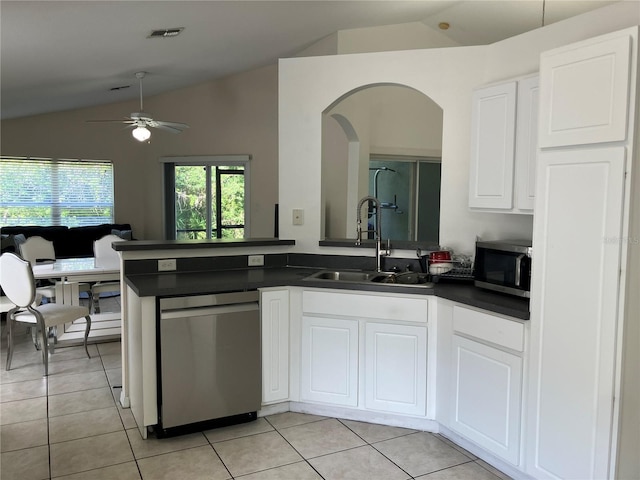 11236 Rouse Run Cir, Orlando, FL 32817 - kitchen featuring stainless steel appliances, vaulted ceiling, dark countertops, arched walkways, and a ceiling fan