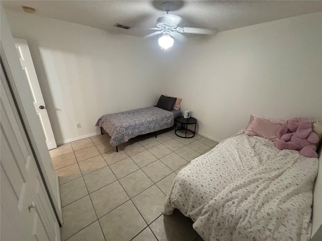 11236 Rouse Run Cir, Orlando, FL 32817 - bedroom with light tile patterned floors and ceiling fan
