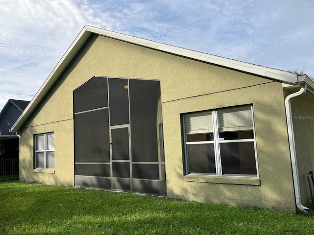 11236 Rouse Run Cir, Orlando, FL 32817 - view of side of property with stucco siding and a lawn
