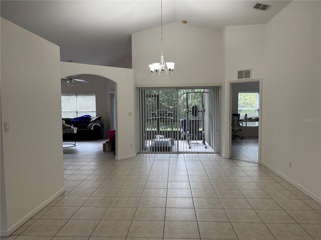 11236 Rouse Run Cir, Orlando, FL 32817 - spare room with arched walkways, light tile patterned flooring, a chandelier, healthy amount of natural light, and high vaulted ceiling