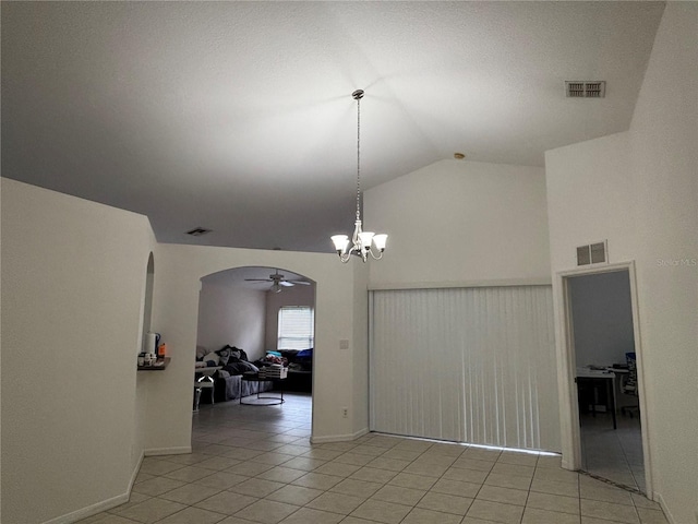 11236 Rouse Run Cir, Orlando, FL 32817 - empty room with a ceiling fan, light tile patterned flooring, high vaulted ceiling, arched walkways, and a chandelier