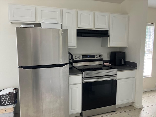 11236 Rouse Run Cir, Orlando, FL 32817 - kitchen with appliances with stainless steel finishes, under cabinet range hood, dark countertops, and white cabinets