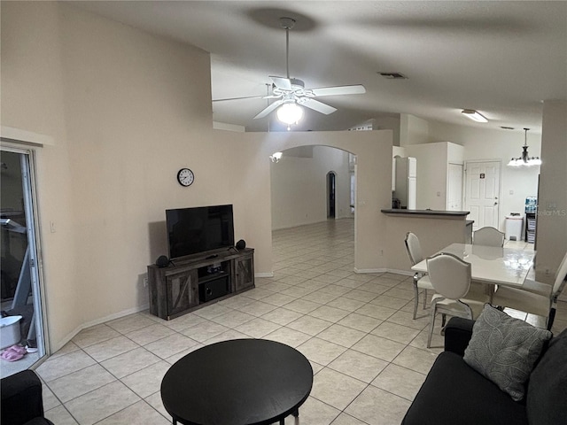 11236 Rouse Run Cir, Orlando, FL 32817 - living area with vaulted ceiling, arched walkways, light tile patterned flooring, a ceiling fan, and a chandelier