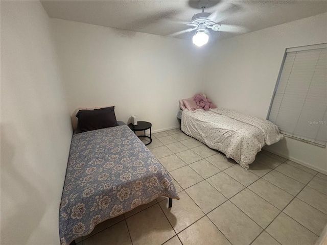 11236 Rouse Run Cir, Orlando, FL 32817 - bedroom featuring light tile patterned flooring, a ceiling fan, and a textured ceiling