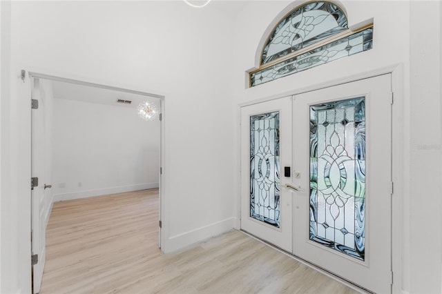 10001 Newington Dr, Orlando, FL 32836 - foyer entrance with french doors, light wood finished floors, and baseboards