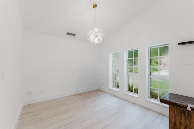10001 Newington Dr, Orlando, FL 32836 - spare room featuring a chandelier, wood finished floors, baseboards, and high vaulted ceiling