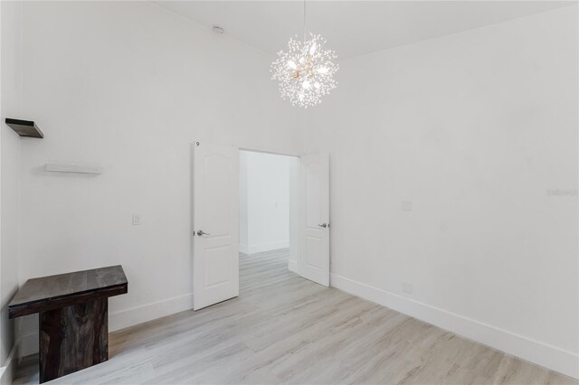 10001 Newington Dr, Orlando, FL 32836 - empty room featuring baseboards, a chandelier, and wood finished floors