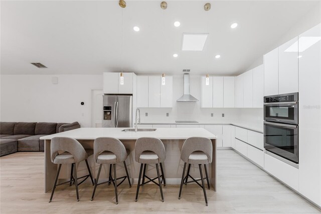 10001 Newington Dr, Orlando, FL 32836 - kitchen with stainless steel appliances, a sink, wall chimney exhaust hood, modern cabinets, and recessed lighting