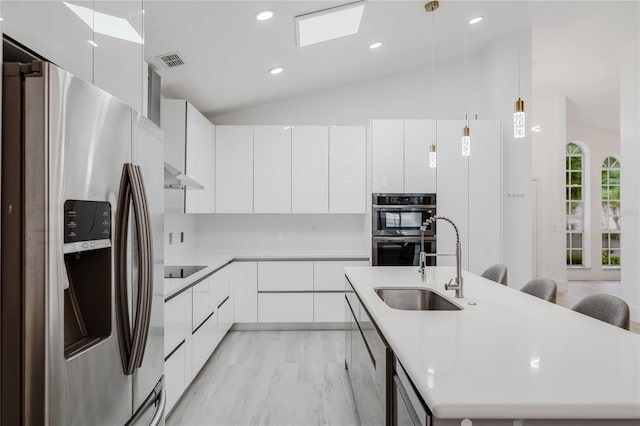 10001 Newington Dr, Orlando, FL 32836 - kitchen featuring stainless steel appliances, modern cabinets, a sink, lofted ceiling, and white cabinetry