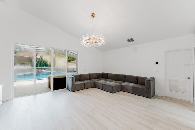 10001 Newington Dr, Orlando, FL 32836 - unfurnished living room with a chandelier, wood finished floors, and high vaulted ceiling
