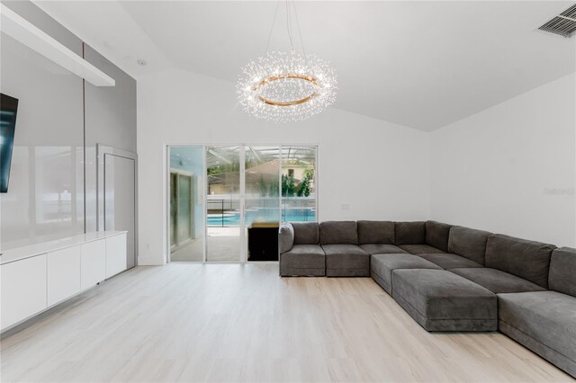 10001 Newington Dr, Orlando, FL 32836 - living area featuring vaulted ceiling, a chandelier, and wood finished floors