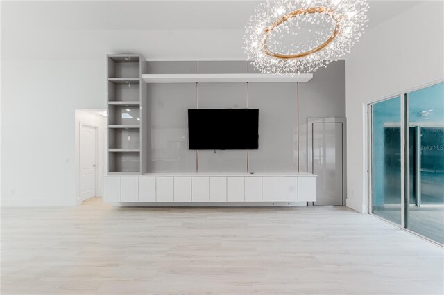 10001 Newington Dr, Orlando, FL 32836 - unfurnished living room featuring light wood-style floors, a chandelier, and baseboards