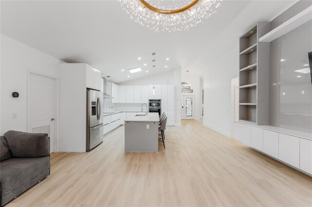 10001 Newington Dr, Orlando, FL 32836 - kitchen with appliances with stainless steel finishes, open floor plan, a sink, a breakfast bar, and white cabinets