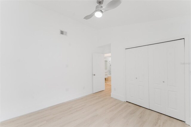 10001 Newington Dr, Orlando, FL 32836 - unfurnished bedroom with wood finished floors, a closet, baseboards, a ceiling fan, and vaulted ceiling