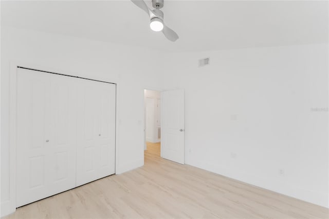 10001 Newington Dr, Orlando, FL 32836 - unfurnished bedroom with wood finished floors, a closet, baseboards, and a ceiling fan