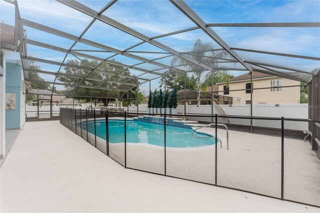 10001 Newington Dr, Orlando, FL 32836 - view of pool featuring a patio area, glass enclosure, and an in-ground hot tub