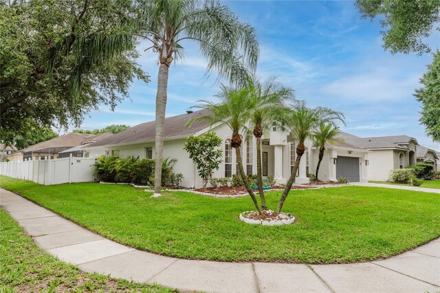 10001 Newington Dr, Orlando, FL 32836 - view of front facade with stucco siding, a garage, and concrete driveway