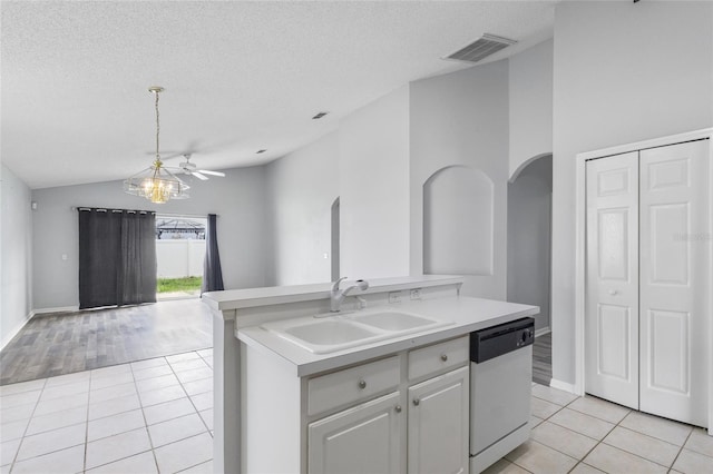 631 Lady Diana Dr, Davenport, FL 33837 - kitchen featuring white dishwasher, a sink, arched walkways, lofted ceiling, and light tile patterned flooring
