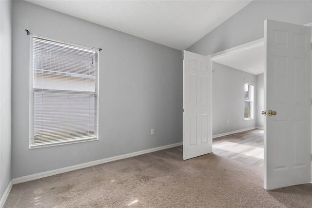 631 Lady Diana Dr, Davenport, FL 33837 - spare room featuring carpet floors, baseboards, and lofted ceiling