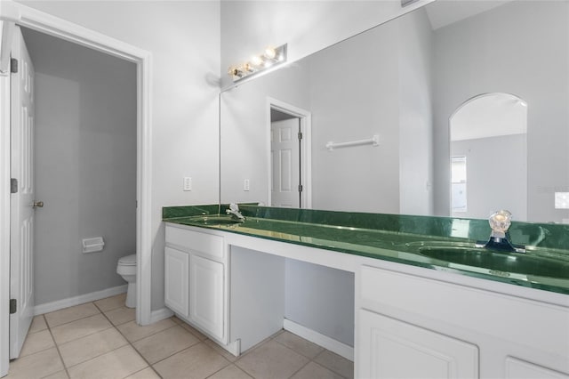 631 Lady Diana Dr, Davenport, FL 33837 - bathroom featuring double vanity, toilet, tile patterned flooring, and baseboards