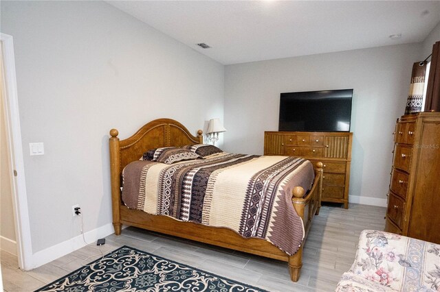 309 E 13th St, Apopka, FL 32703 - bedroom with baseboards and wood finish floors