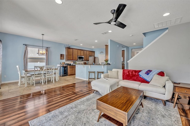 11616 Thacker Dr, Clermont, FL 34711 - living area with light wood-type flooring, beverage cooler, a ceiling fan, and recessed lighting