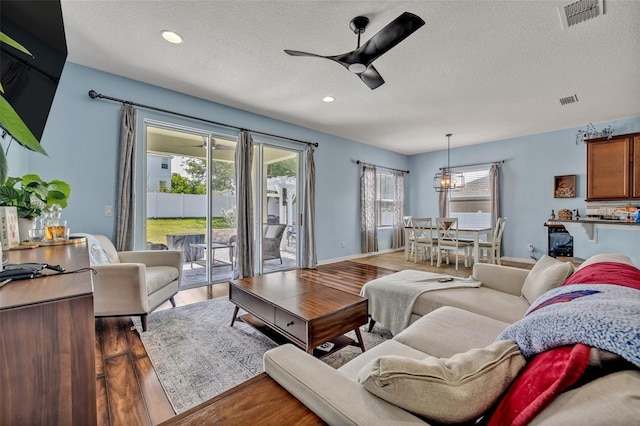 11616 Thacker Dr, Clermont, FL 34711 - living room featuring ceiling fan, a textured ceiling, wood finished floors, and recessed lighting