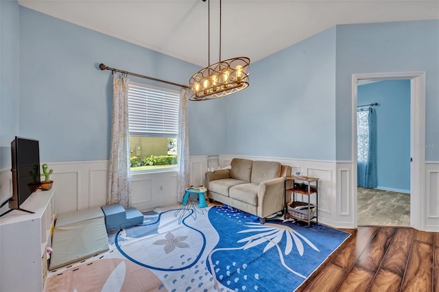 11616 Thacker Dr, Clermont, FL 34711 - living room with wood finished floors, healthy amount of natural light, wainscoting, a chandelier, and a decorative wall