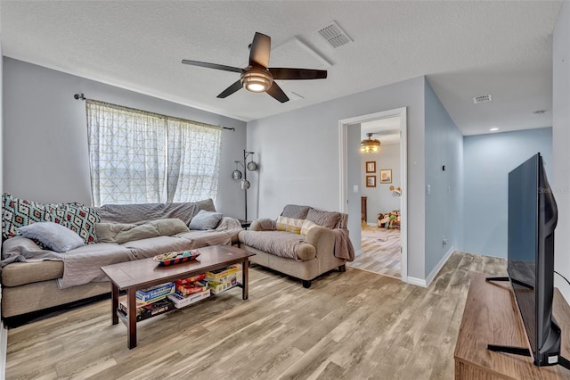 11616 Thacker Dr, Clermont, FL 34711 - living room with ceiling fan, light wood-style flooring, and a textured ceiling