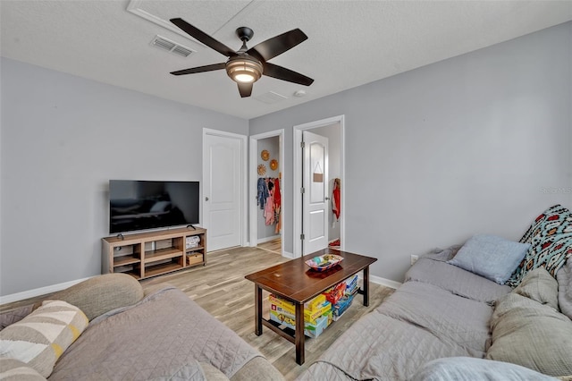 11616 Thacker Dr, Clermont, FL 34711 - living area featuring a ceiling fan, light wood-style floors, and a textured ceiling