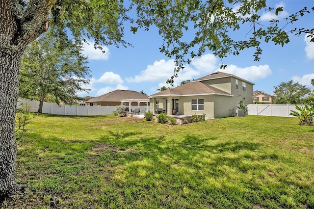 11616 Thacker Dr, Clermont, FL 34711 - back of property featuring stucco siding, a patio, and a fenced backyard