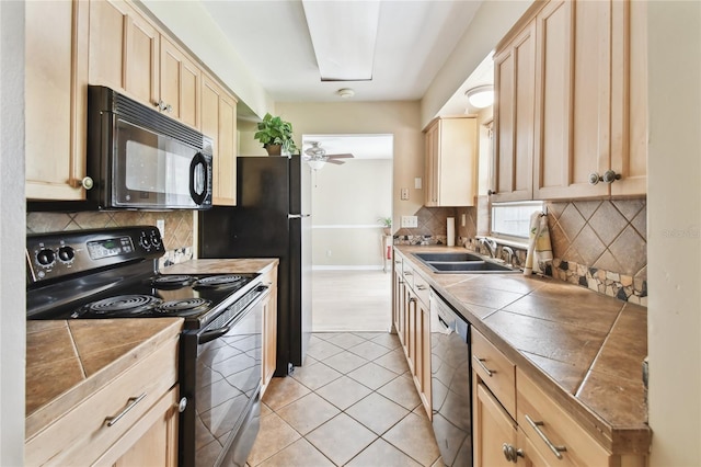 191 Ruskin St, Lake Mary, FL 32746 - kitchen featuring black appliances, light brown cabinets, tile countertops, and backsplash