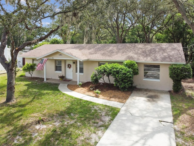 191 Ruskin St, Lake Mary, FL 32746 - ranch-style home with stucco siding, roof with shingles, concrete driveway, and a front yard