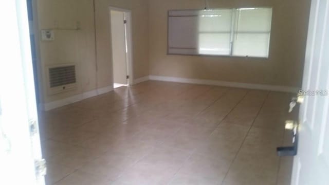 2260 Willie Mays Pkwy, Orlando, FL 32811 - spare room with light tile patterned floors, baseboards, and heating unit