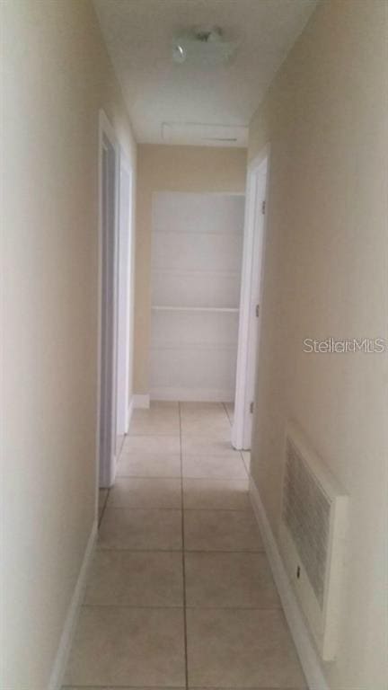 2260 Willie Mays Pkwy, Orlando, FL 32811 - hallway with light tile patterned floors and baseboards