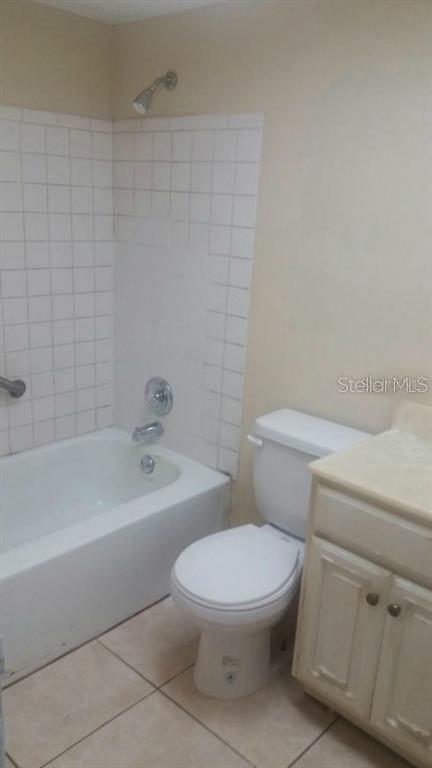 2260 Willie Mays Pkwy, Orlando, FL 32811 - bathroom with tile patterned flooring, vanity, toilet, and shower / tub combination