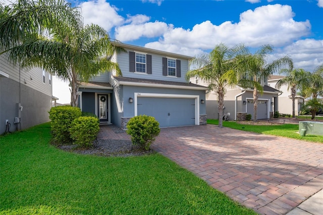 3943 Crawley Down Loop, Sanford, FL 32773 - view of front of property with decorative driveway, a garage, a front yard, stucco siding, and stone siding