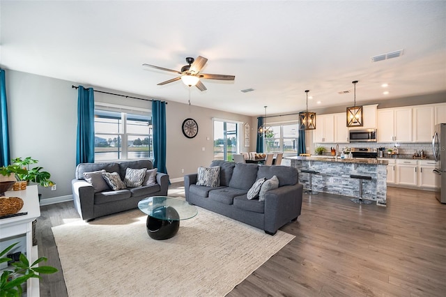 3943 Crawley Down Loop, Sanford, FL 32773 - living room featuring dark wood-style flooring, baseboards, ceiling fan, and recessed lighting