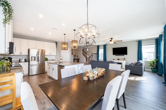 3943 Crawley Down Loop, Sanford, FL 32773 - dining room with a chandelier, ceiling fan, stairway, wood finished floors, and recessed lighting