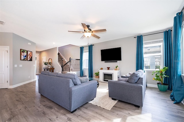 3943 Crawley Down Loop, Sanford, FL 32773 - living room featuring stairs, wood finished floors, ceiling fan, and baseboards