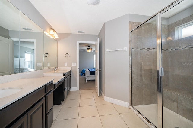 3943 Crawley Down Loop, Sanford, FL 32773 - ensuite bathroom with double vanity, a ceiling fan, a stall shower, and baseboards