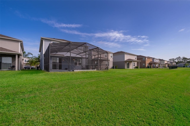 3943 Crawley Down Loop, Sanford, FL 32773 - back of house with a yard, glass enclosure, and a residential view