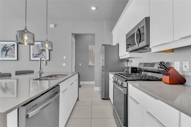 7740 Sandy Ridge Dr Unit 124, Reunion, FL 34747 - kitchen featuring stainless steel appliances, a sink, white cabinets, pendant lighting, and light countertops