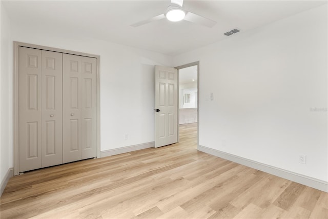7446 Houston Ct E, Winter Park, FL 32792 - unfurnished bedroom with light wood finished floors, baseboards, ceiling fan, and a closet