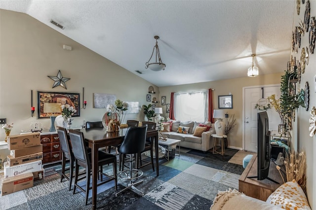 1907 Myakka Ct, Poinciana, FL 34759 - dining area with vaulted ceiling and a textured ceiling