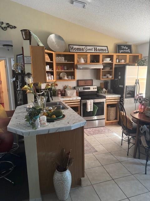 1907 Myakka Ct, Poinciana, FL 34759 - kitchen with stainless steel appliances, open shelves, under cabinet range hood, a textured ceiling, and light countertops